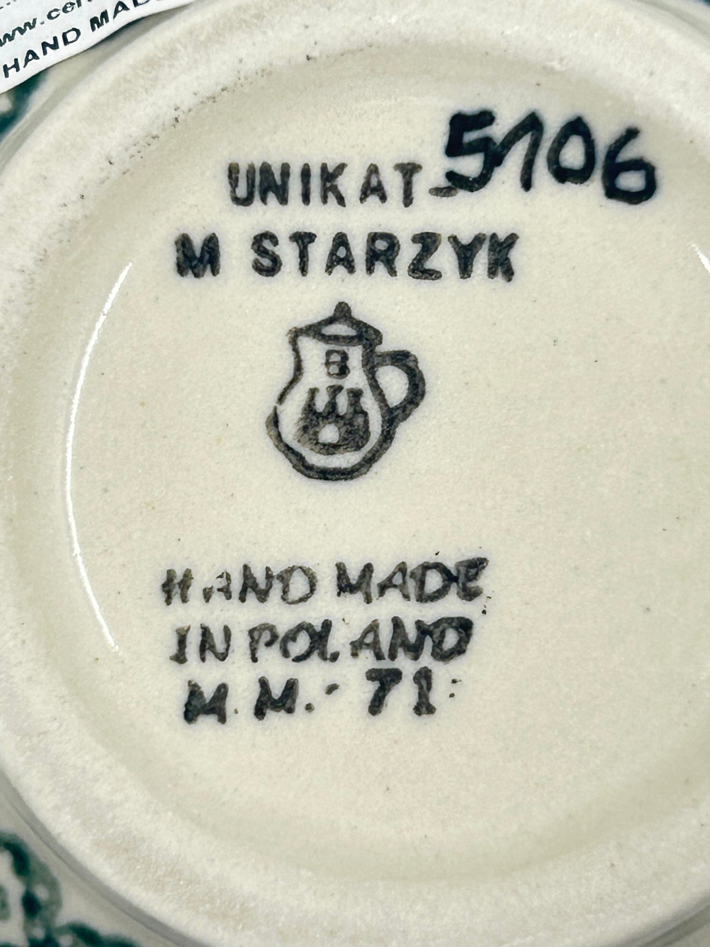 Bottom base of a Ceramika Artystyczna Unikat Polish pottery bubble mug, showing pattern number 5106, factory stamp, and unglazed foot ring.