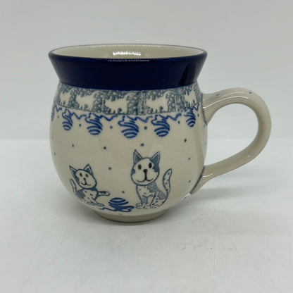 Side profile view of a Ceramika Artystyczna Polish pottery bubble mug featuring hand-painted blue cats, a ball of yarn, a cat silhouette border, and a solid blue rim.