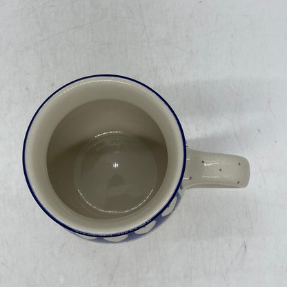 Top-down view into a Ceramika Artystyczna Polish pottery bubble mug, revealing a glossy, smooth off-white interior, a thin dark blue rim, and a right-facing handle with subtle dotted accents.