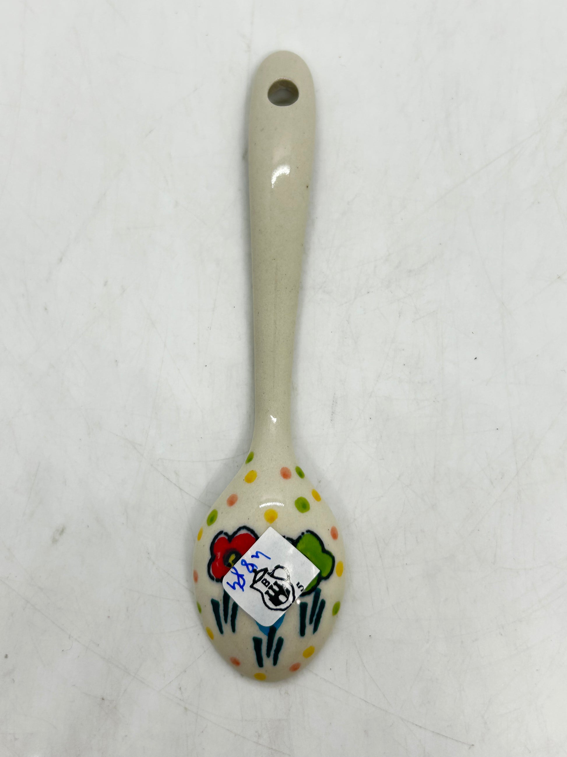 Close-up of the unglazed back of a Ceramika Artystyczna Polish pottery miniature spoon, showing the Bolesławiec pitcher factory stamp.