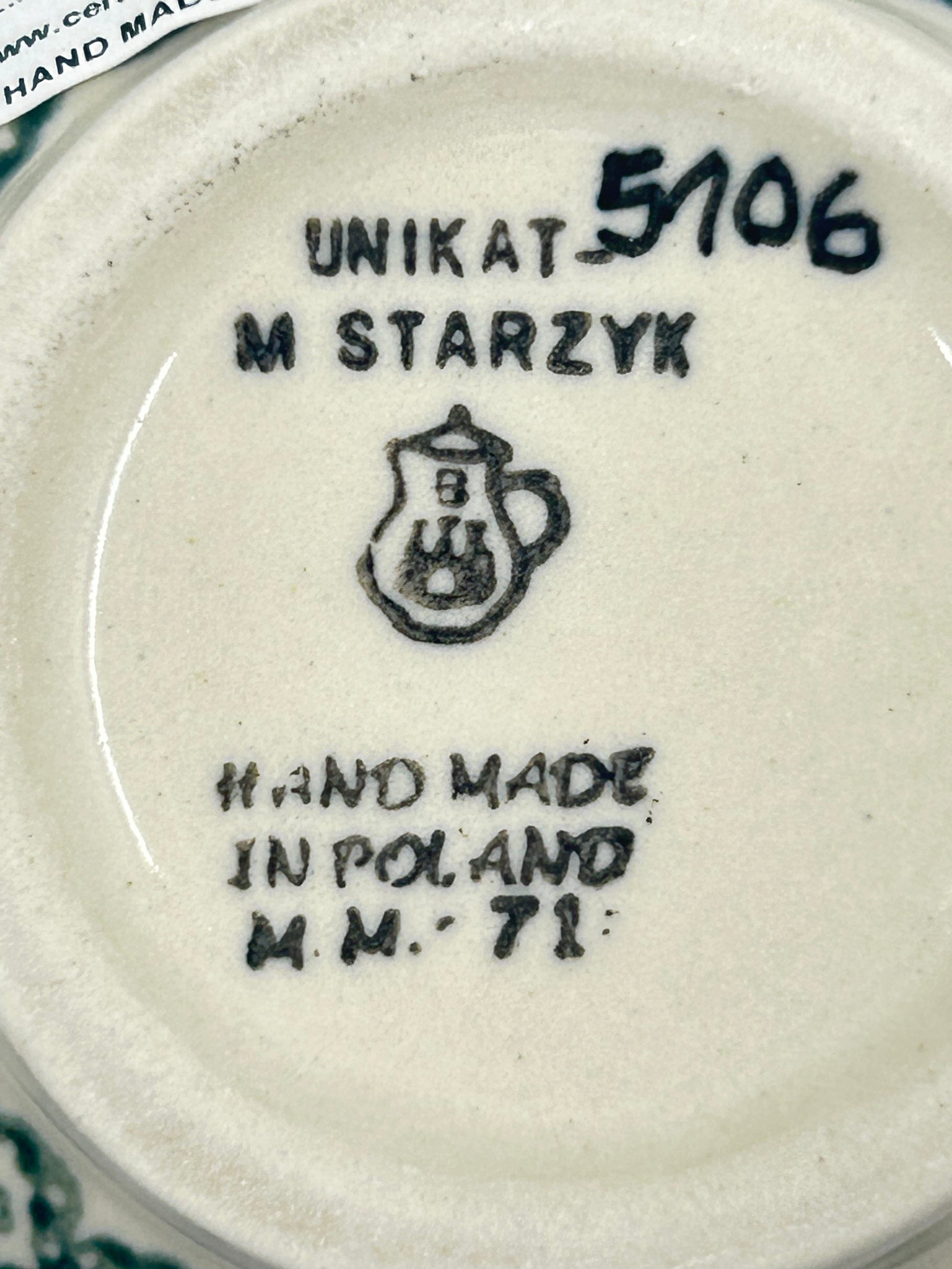 Bottom base of a Ceramika Artystyczna Unikat Polish pottery bubble mug, showing pattern number 5106, factory stamp, and unglazed foot ring.