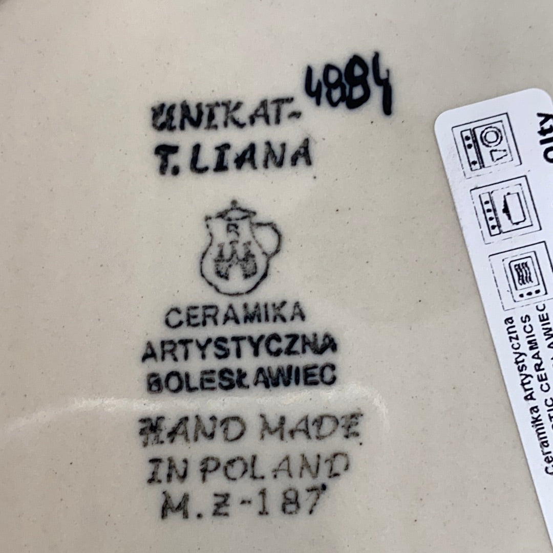 Bottom base of a Ceramika Artystyczna Polish pottery plate showing the UNIKAT signature stamp for T. Liana, and a hand-painted number 4884.